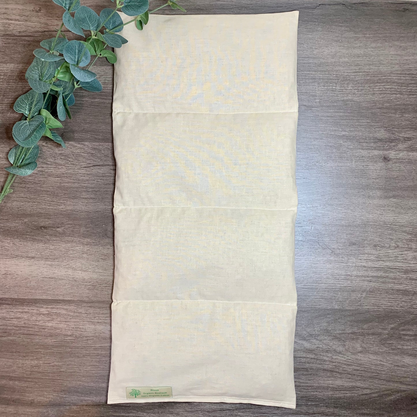 wooden background showing the heating pad sewn in four sections so the heat is evenly distributed.