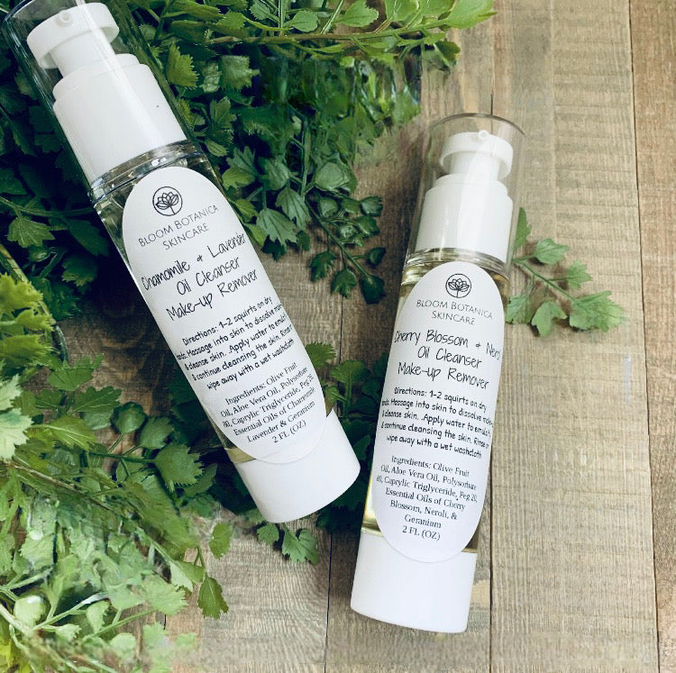 Chamomile & Lavender Oil Cleanser & gentle Make-up remover featuerd on a wooden background with greenery. Comes in 4 sizes.