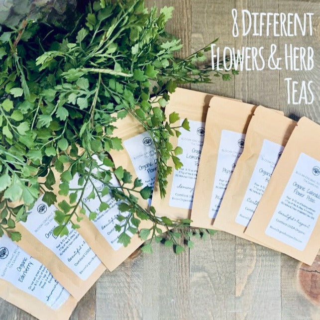 set of eight different flowers and herbs. All are culinary and come in a food-grade resealable packet. displayed on a wooden background with green leaves.